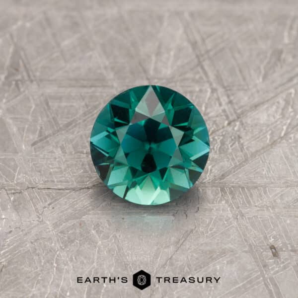 A blue-green tourmaline in a classic diamond round brilliant design