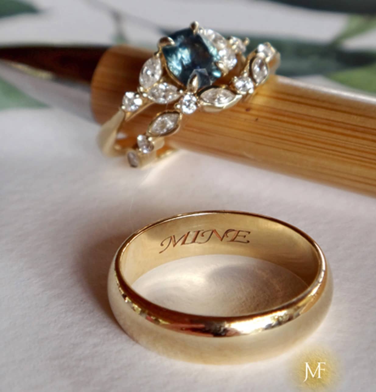 A photo from a customer review featuring The "Cattleya" ring in 14k yellow gold with 1.40-carat Montana sapphire; the Thames band in 14k yellow gold; and the classic standard-fit band in 14k yellow gold