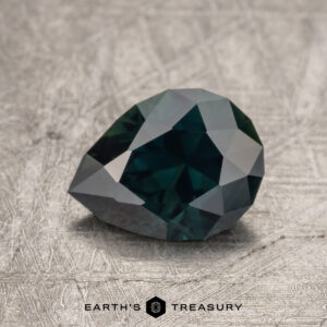 A 1.66-carat Australian sapphire from Earth's Treasury displayed on a textured surface.