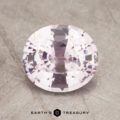 A close-up image of a 2.32-Carat faceted oval sapphire with a light pink hue, set against a textured neutral background. The logo for "Earth's Treasury" is visible at the bottom center of the image.