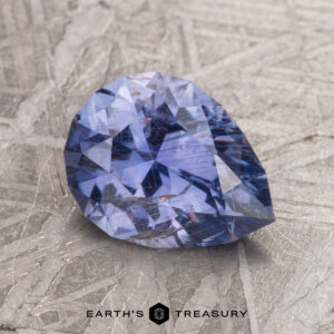 A 2.04-carat Violet Blue Umba Sapphire set against a textured metallic surface.