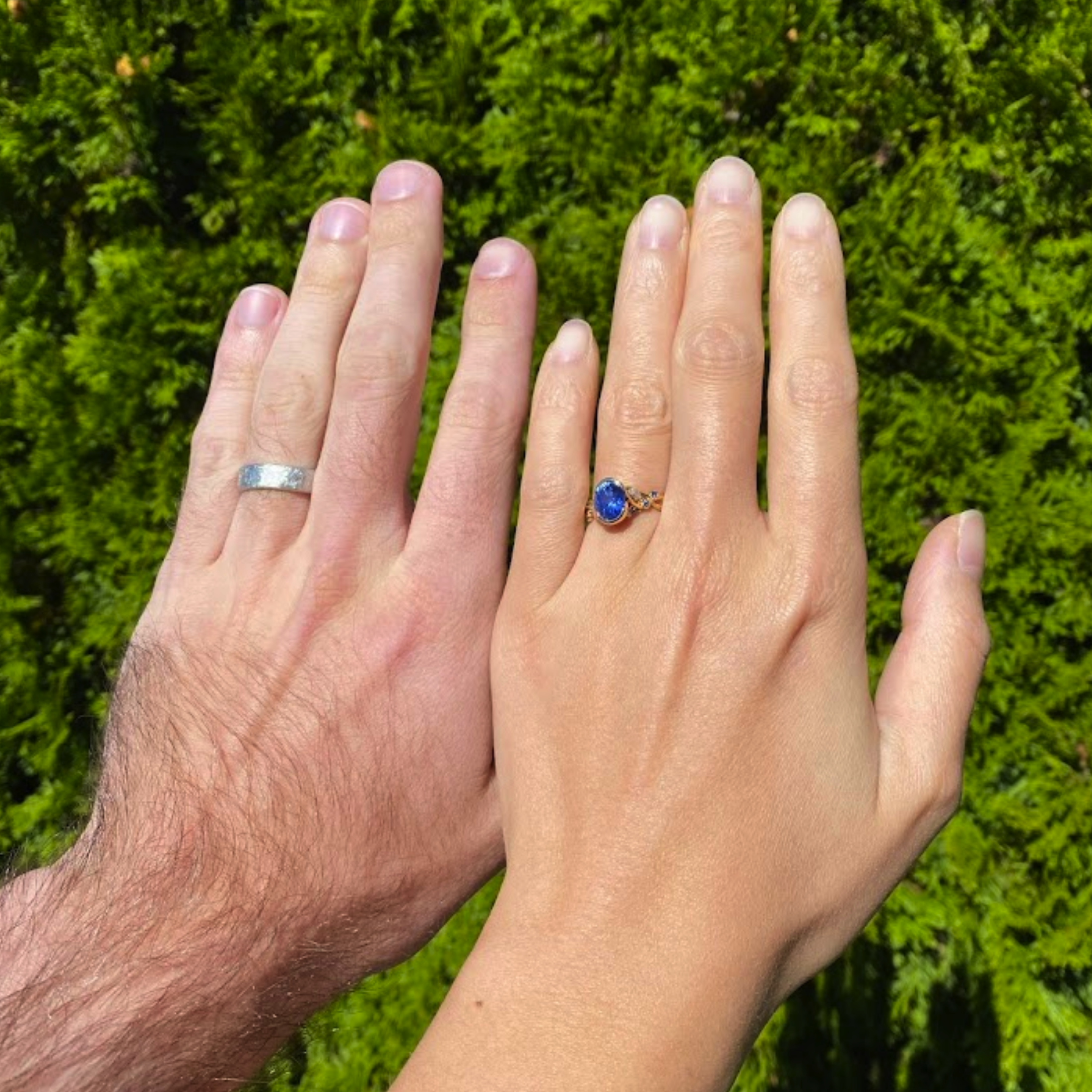 A custom ring in 18k yellow gold with a 2.55-carat Madagascar sapphire, as well as a custom men's band in platinum